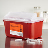 A red plastic NDC sharps container with OSHA-compliant safety features.